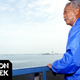 New York City Mayor David Dinkins gazes over New York Harbor from the Staten Island Ferry as it passes the Statue of Liberty in 1992 in New York.